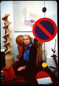 A portrait of Betty Parsons surrounded by art.