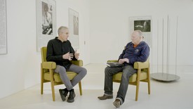 Adam McEwen and Ian Penman seated in yellow chairs