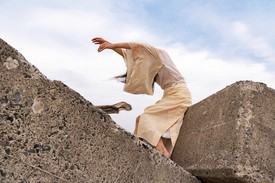Eiko Otake stands on what was part of the original seawall next to the Tomioka Fishing Harbor.