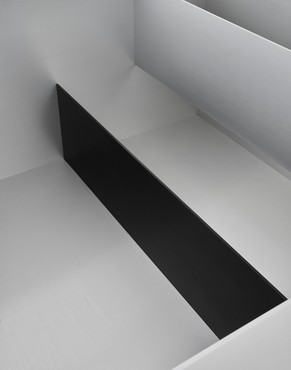 Aluminum box that is open on the top and has a black aluminum divider and a silver aluminum divider inside