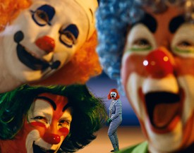 A photograph by artist Cindy Sherman. The artist as four different clowns in a colorful, rectangular composition.