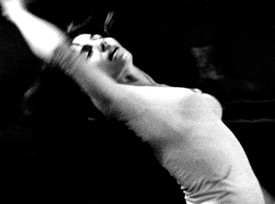 Black-and-white photograph of Aileen Passloff dancing in 1964. She is arched in a backbend, arm over her head