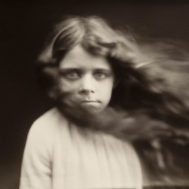 AI-generated artwork of a child staring at the viewer with their hair blowing to the side