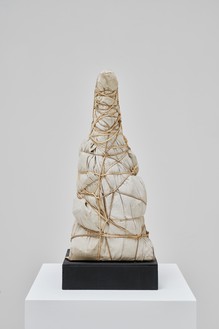 Christo, Package, 1960 Embroidered table cloth and rope, 19 ¾ × 8 ¼ × 7 ⅛ inches (50 × 21 × 18 cm)© Christo and Jeanne-Claude Foundation. Photo: Thomas Lannes