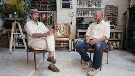 Spencer Sweeney and Peter Doig sitting on chairs in Sweeney’s studio